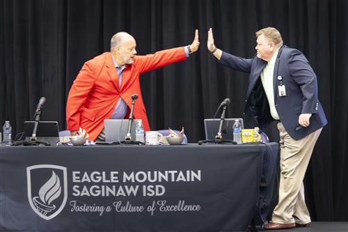 two men give each other high five